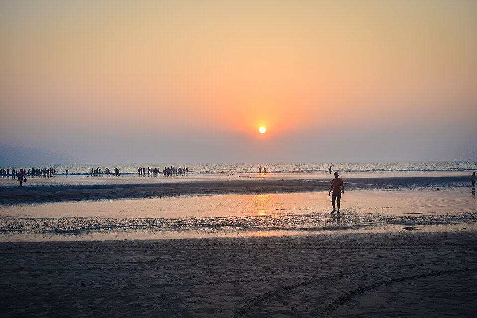 Sunset over Inani Beach, Cox's Bazar, Bangladesh — rocky foreshore and golden light on open sea