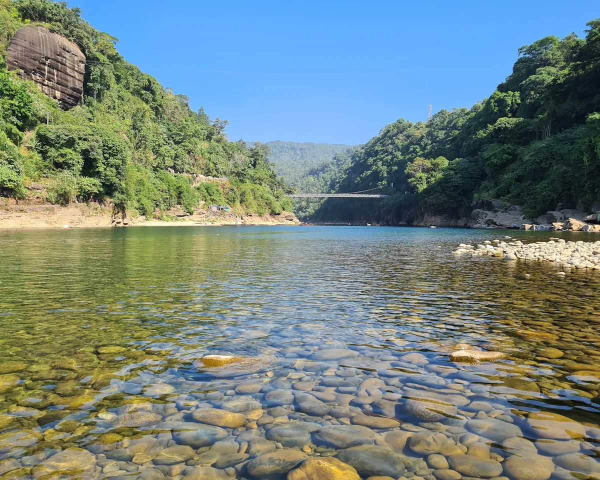 Crystal-clear river water over smooth stones at Jaflong, near the Meghalaya border